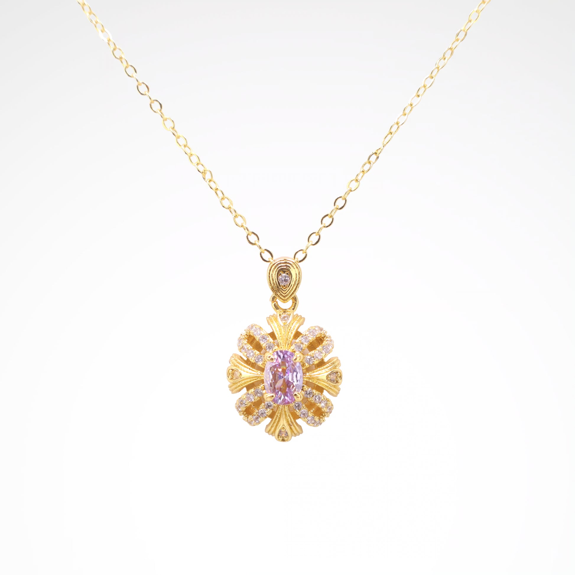 Imperial Lavender Gold-Tone Ribbon Pendant Necklace, gold plated copper with zircon stones with a white background