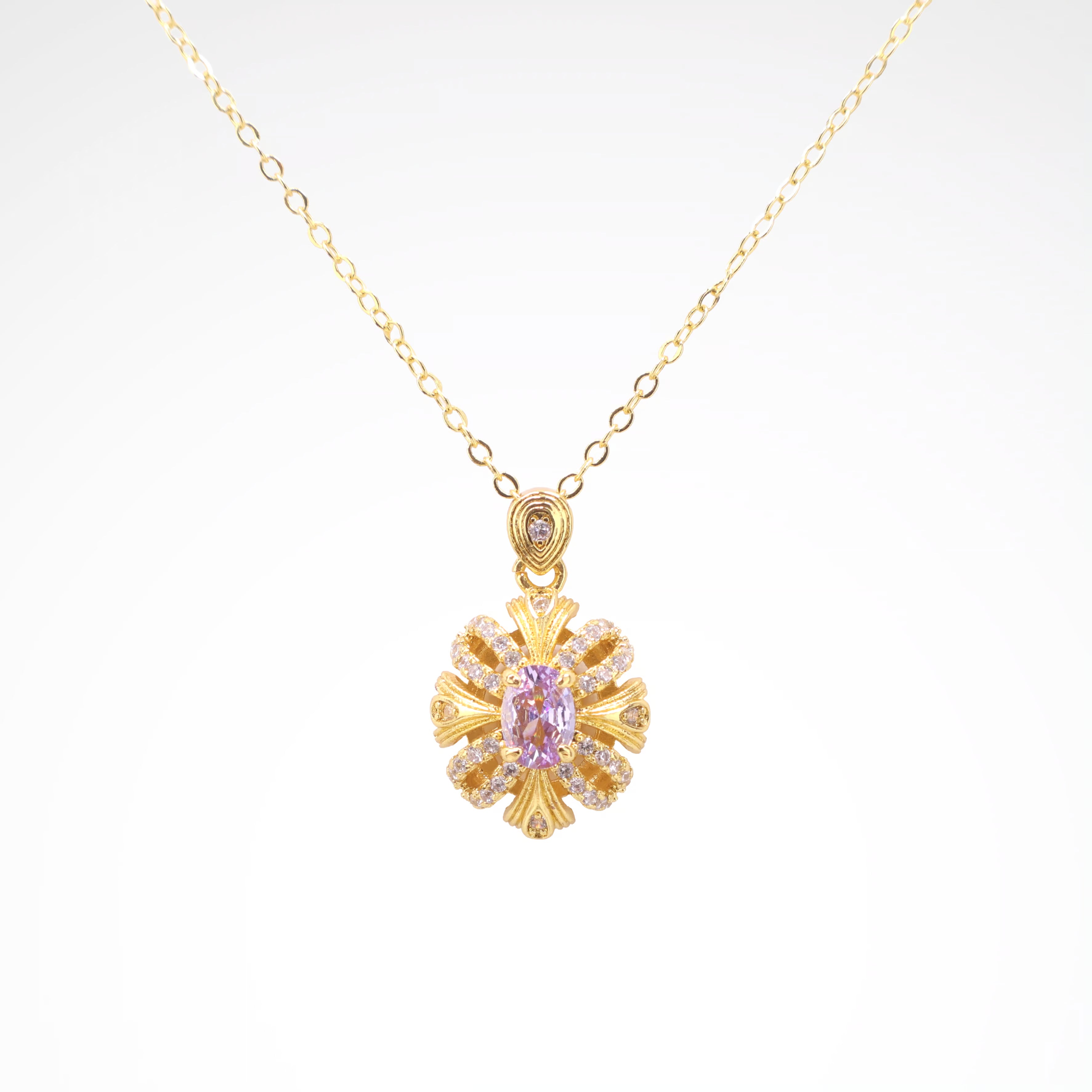 Imperial Lavender Gold-Tone Ribbon Pendant Necklace, gold plated copper with zircon stones with a white background