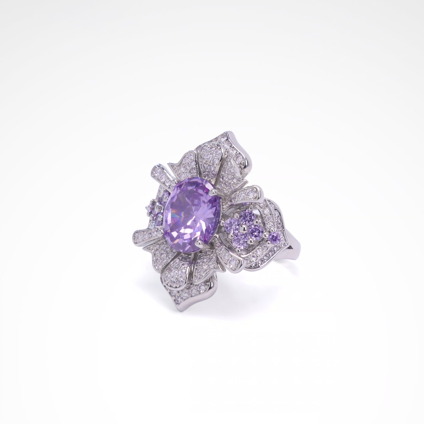 Silver ring with a purple gemstone on a white background