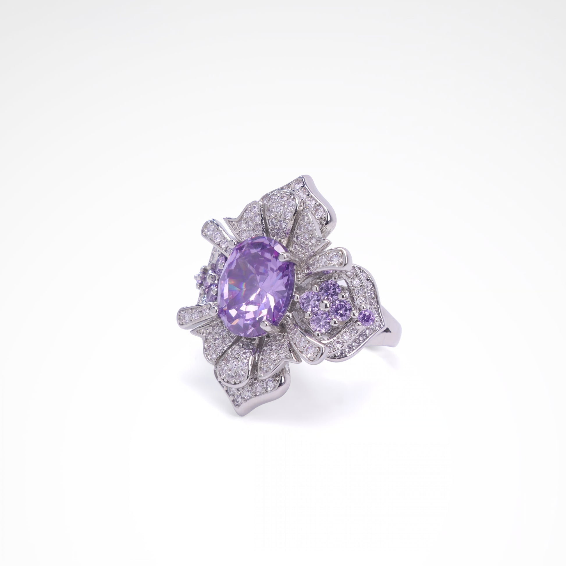 Silver ring with a purple gemstone on a white background