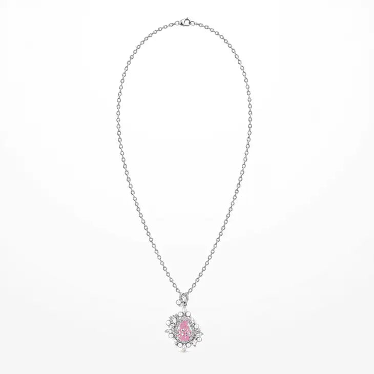 A delicate white gold plated chain necklace featuring a small floral pendant with a central pink zircon and clear accent zircon, displayed against a clean white background.