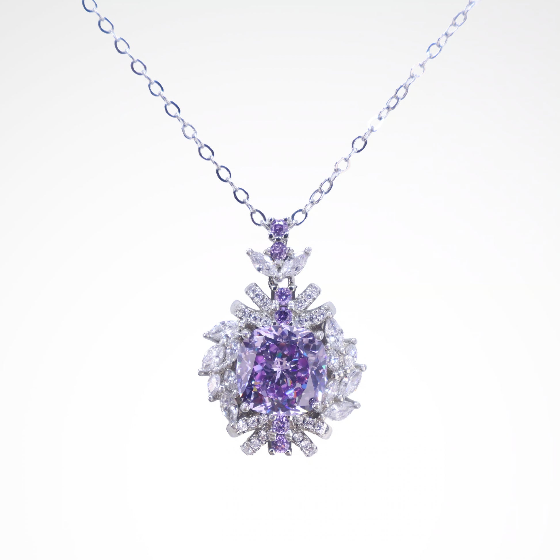 Regal Violet Cushion-Cut Floral Pendant Necklace, white-gold plated copper with zircon stones with a white background