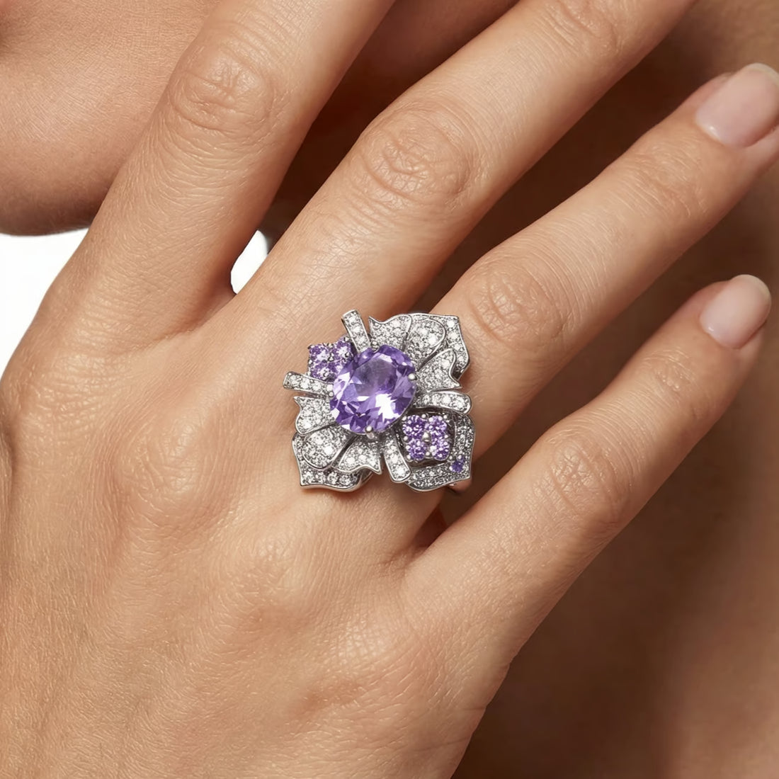 Silver ring with a purple gemstone on a white background